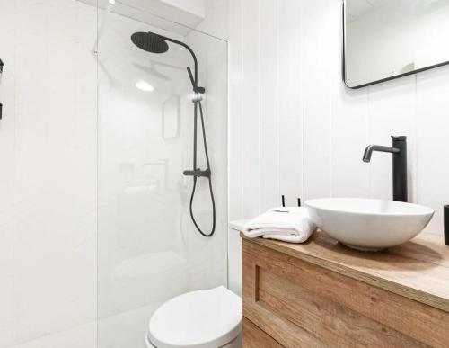 a bathroom with a white sink and a shower at El Nido Rural Boutique Villa in La Focella
