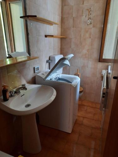a bathroom with a sink and a toilet at Mansarda Carona in Carona