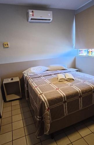a bedroom with a bed in a room with a heater at Escuna Praia Hotel in João Pessoa