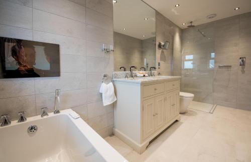 a bathroom with a tub and a sink and a toilet at The Royal Duchy Hotel in Falmouth