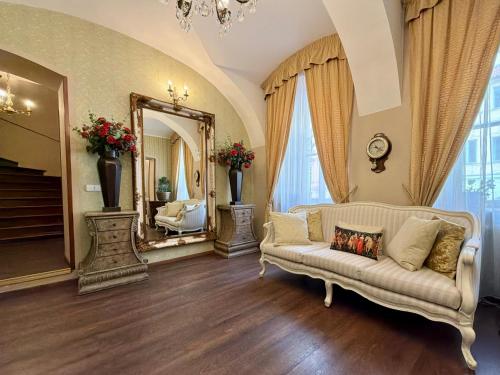a living room with a couch and a mirror at Prague Golden Age in Prague