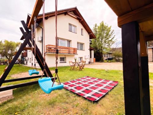 a swing in the yard of a house at Apartamenty Pawełek in Zator
