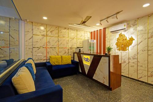 a meeting room with blue couches and a podium in a room with a map at FabHotel GG Stays in Lingampalli