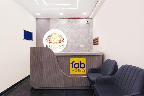 a waiting room with two chairs and a sign at FabHotel Prime Rosens in Māripat