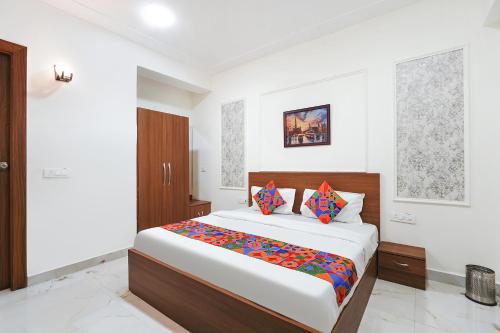 a bedroom with a large bed in a room at FabHotel Prime Rosens in Māripat