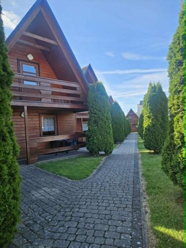 a cobblestone path leading to a house at DELFIN - Lawendowy Zakątek in Sianozety