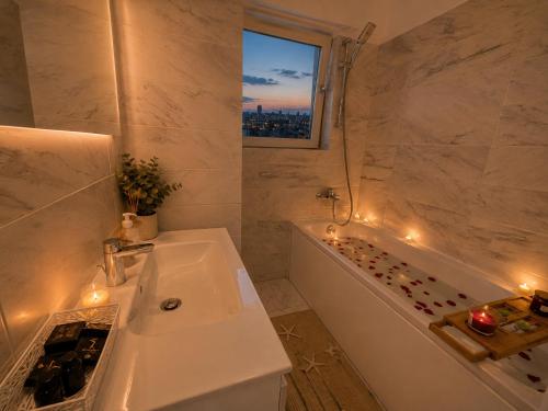 a bathroom with a sink and a tub and a window at CENTRAL Apartment 84- free parking- spital Recuperare in Iaşi