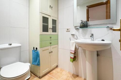 a bathroom with a toilet and a sink at Lamar Suites in Arinaga