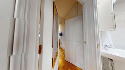 a hallway with a sink and a white door at Walton Lane in Oxford