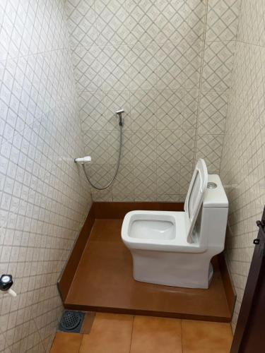 a bathroom with a toilet in a stall at Elowen Suites in Manjeri