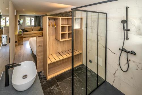 a bathroom with a shower and a toilet in a room at Hôtel-Restaurant Logis l'Aubrac Laguiole in Laguiole