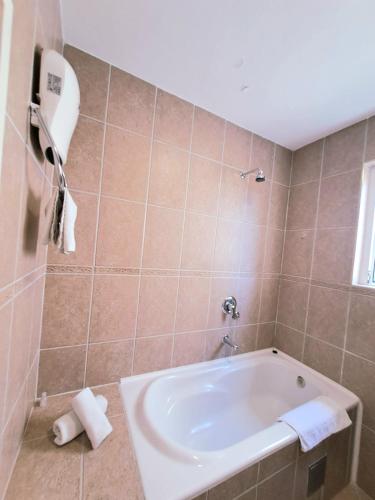 a bathroom with a tub and a sink at House Leana Herceg Novi in Herceg-Novi