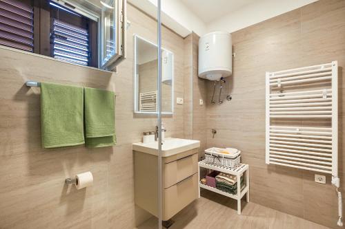 a bathroom with a sink and a mirror at Rooms Feme in Trogir
