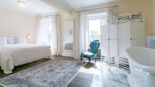 a bedroom with a bed and a bath tub and a tub at Number eight in Beaumaris