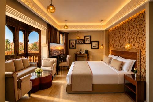 a hotel room with a bed and a couch at Hivernage Marrakech in Marrakesh