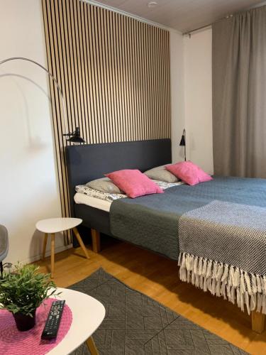 a bedroom with two beds with pink pillows at StarHomes City Studio B16 in Oulu