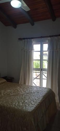 a bedroom with a bed and a large window at Del Centro Dptos in Federación