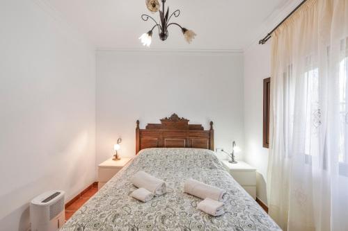 a bedroom with a bed with two pillows on it at Casa El Mure in Ronda