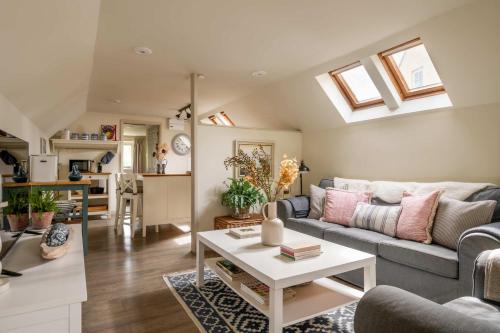 a living room with a couch and a table at The Barn in South Cerney