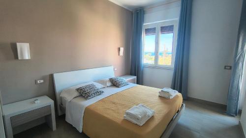 a bedroom with a bed and a window at Casa Michela in Sant'Agnello