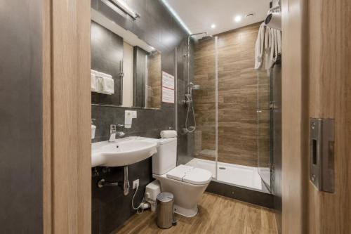 a bathroom with a toilet and a sink and a shower at Poet Art Hotel in Odesa