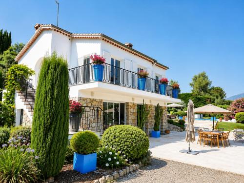 a villa with a garden and a patio at Villa Del Sol with Mountain Views in Vence