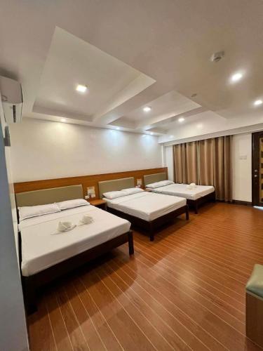 a hospital room with three beds in it at Terra Verde Resort Guindulman Bohol in Guindulman