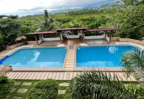 a large swimming pool in front of a house at Terra Verde Resort Guindulman Bohol in Guindulman