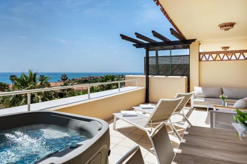 a hot tub on a balcony with the ocean at Malibu Mansions by the beach by ALFRESCO STAYS in Mijas Costa