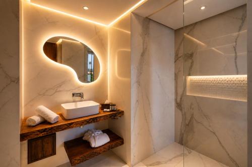 a bathroom with a sink and a mirror at Hivernage Marrakech in Marrakesh