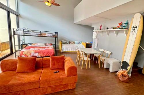 a room with a couch and a bed and a table at Duplex Close to HPU Waikiki Pool Terrace Laundry One and Half Bath for 15person in Honolulu