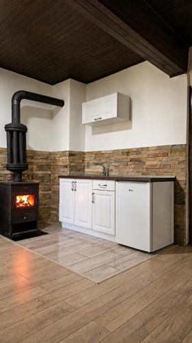 a kitchen with white cabinets and a stove at River Valley Guest House in Foča