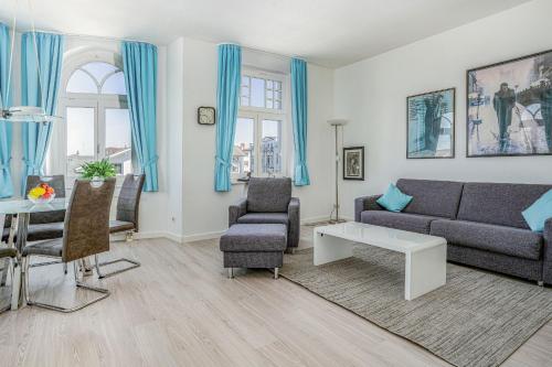 a living room with a couch and a table at Ferienwohnung 10 Haus Metropol in Binz