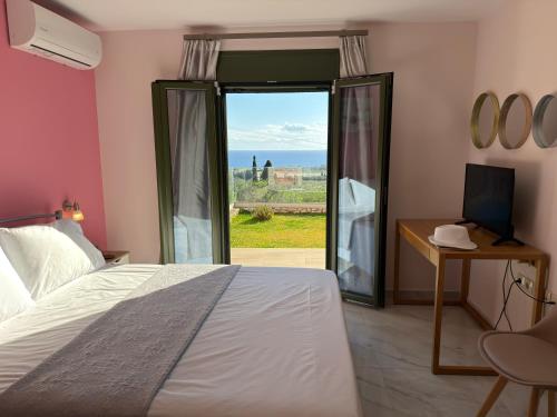 a bedroom with a bed and a sliding glass door at Freesia Grand Sea View Residence in Sarláta