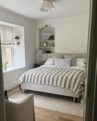 a bedroom with a bed and a window at Stamping Cottage Studio Between St Ives & Penzance in Penzance