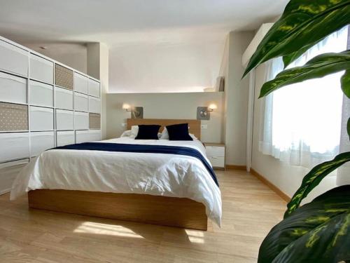 a bedroom with a large bed and a large window at Exclusive Beachfront Penthouse in Almayate Alto