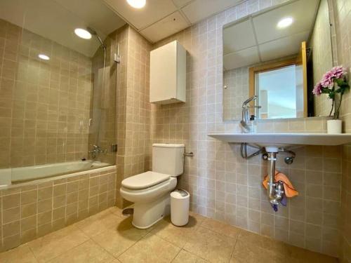 a bathroom with a toilet and a sink at Exclusive Beachfront Penthouse in Almayate Alto