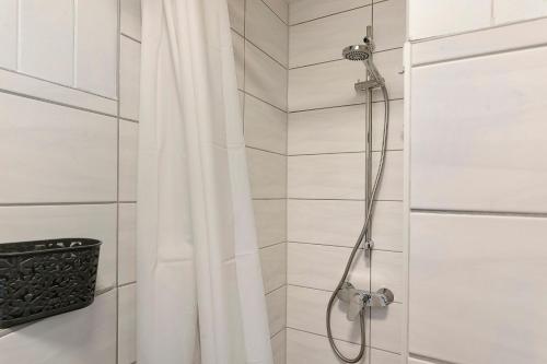 a shower with a white shower curtain in a bathroom at Rosenberg in Katzhütte