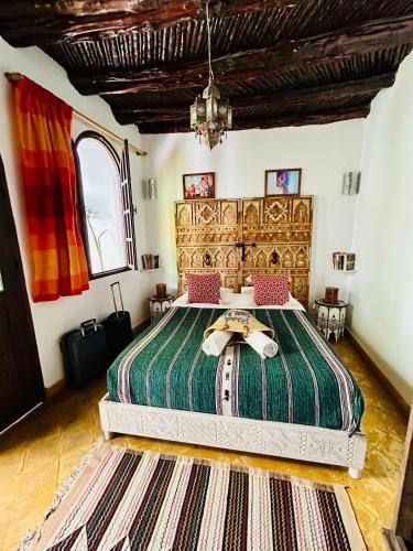 a bedroom with a large bed in a room at Riad Dar Abi in Essaouira