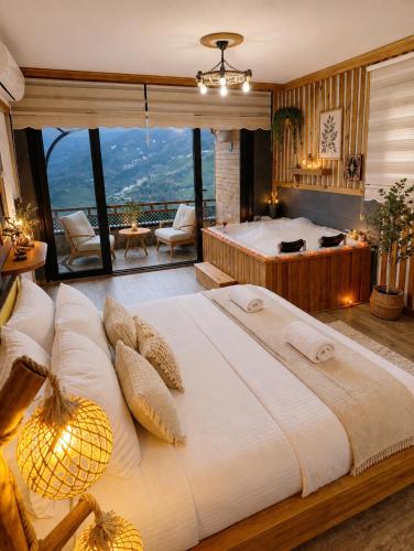 a large bedroom with a large bed with a view at Seyri Alem suit villa Bungalow in Ardeşen
