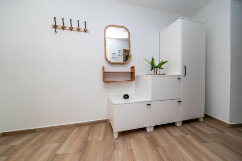 a bathroom with a white cabinet and a mirror at Sant'Antonio in Orlec