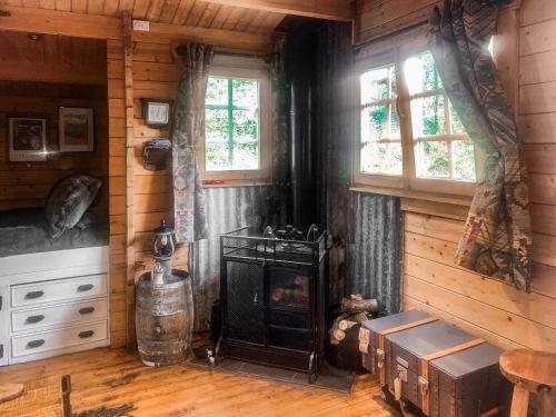 a living room with a stove in a cabin at The Signal Box in Girvan