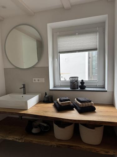 a bathroom with a sink and a mirror at Fichtennest in Sundern