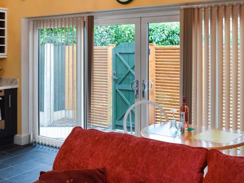 a living room with a sliding glass door at The Squirrels in Great Malvern