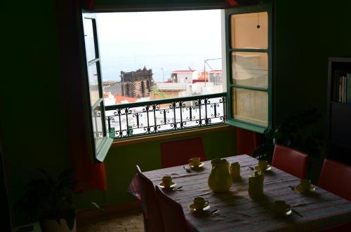 a table with a view of the ocean from a window at Casa Garome 14 PARKING GRATIS in Santa Cruz de la Palma