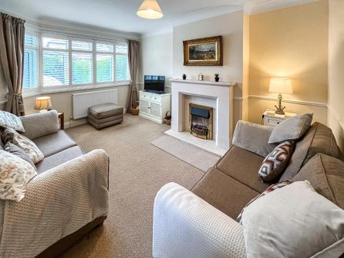 a living room with a couch and a fireplace at Rosemary House in Broadstairs