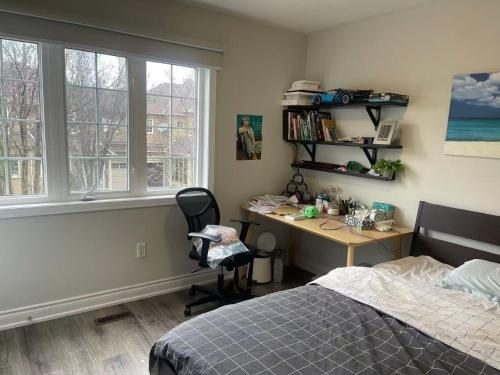 a bedroom with a desk and a bed and a desk and window at Tide Manor in Markham