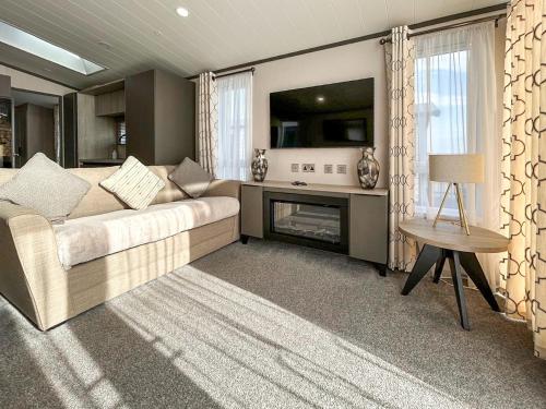 a living room with a couch and a fireplace at Marina Escape One in Peterhead