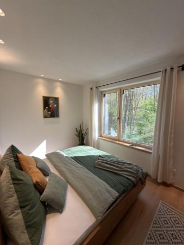 a bedroom with a large bed and a window at WaldQuartier in Memmelsdorf