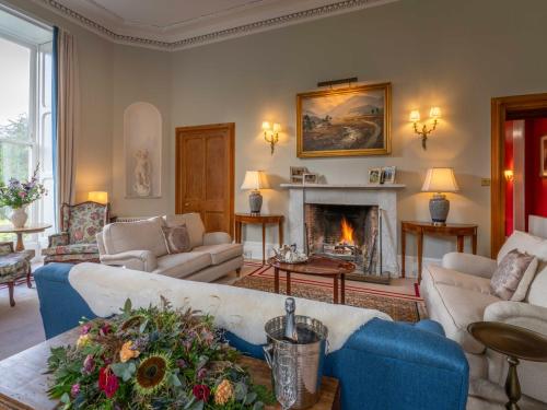 a living room with a couch and a fireplace at Dalnaglar Castle - Uk7072 in Cray